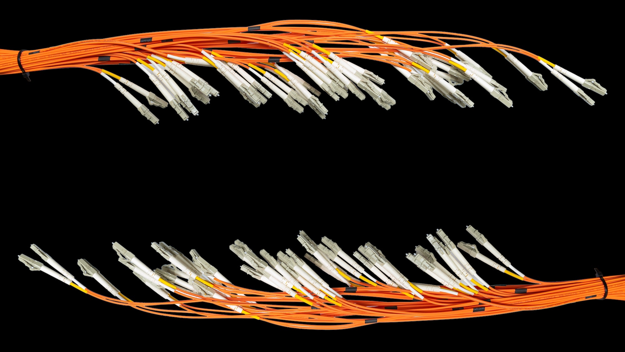 Bunch of fiber optic cables and connectors on black background with copyspace